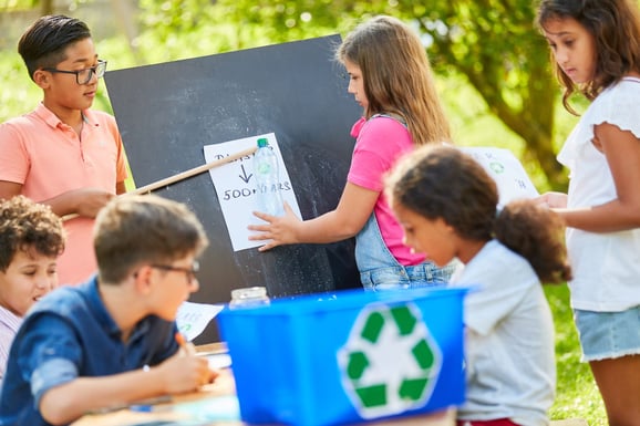 children gathered outside in the nature